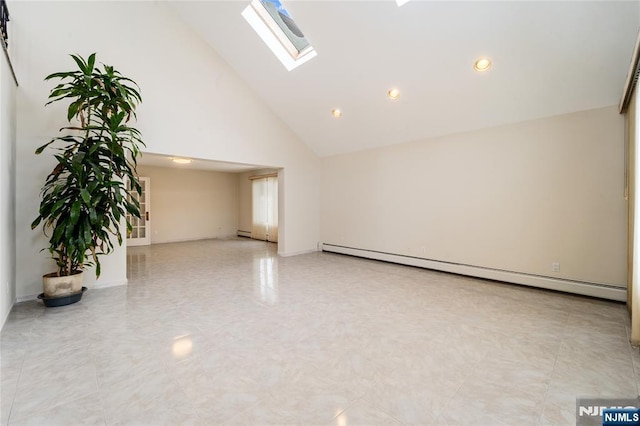 empty room with a baseboard heating unit, high vaulted ceiling, and a skylight