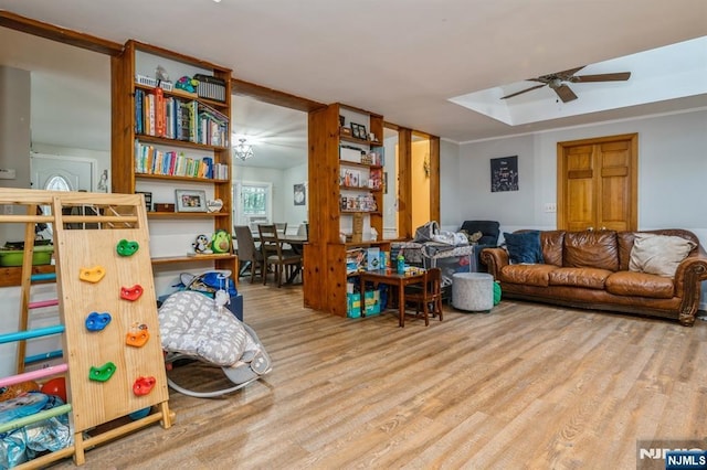 living room featuring wood-type flooring and ceiling fan