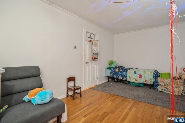 sitting room featuring crown molding and hardwood / wood-style floors