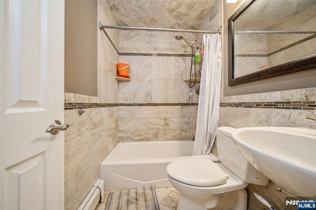 full bathroom with toilet, sink, shower / tub combo, tile walls, and a baseboard heating unit