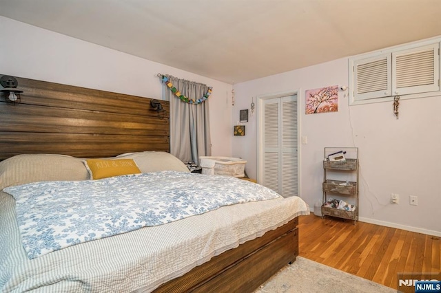 bedroom featuring hardwood / wood-style flooring and a closet