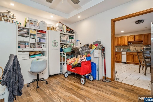 office area with sink, ceiling fan, and light hardwood / wood-style flooring