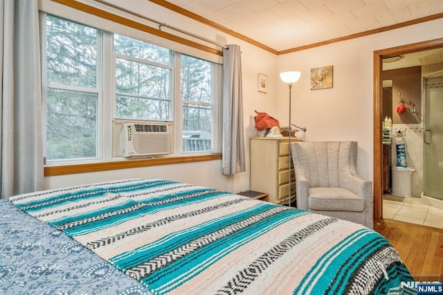 bedroom featuring cooling unit, ornamental molding, and hardwood / wood-style floors