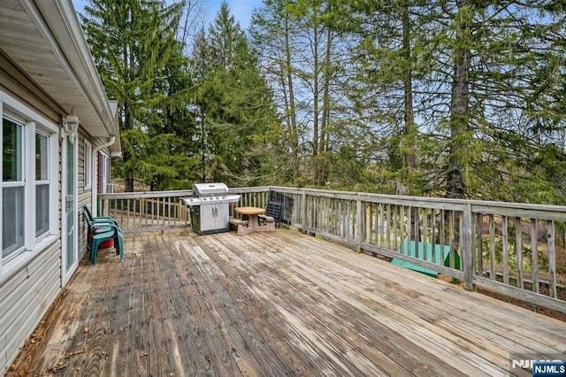 wooden terrace featuring area for grilling