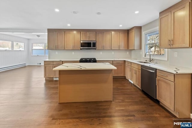 kitchen featuring appliances with stainless steel finishes, a center island, sink, and plenty of natural light