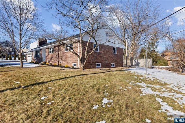 view of side of home featuring a yard