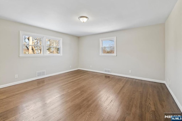 unfurnished room with dark hardwood / wood-style floors