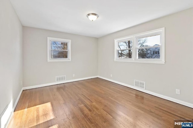 unfurnished room with wood-type flooring