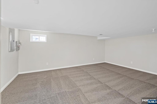 basement featuring carpet flooring and electric panel