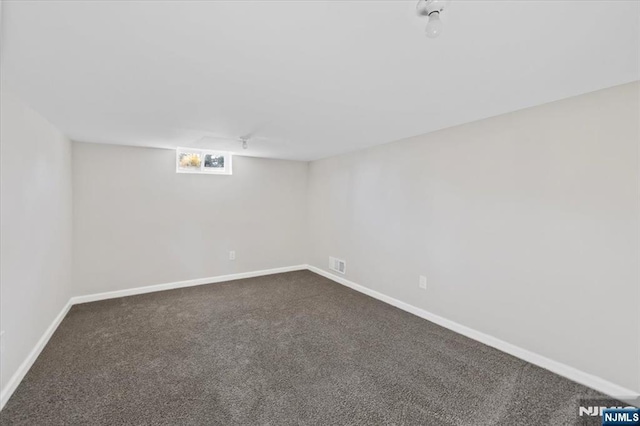 basement with dark colored carpet