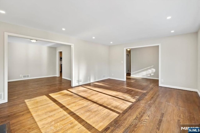 empty room with hardwood / wood-style flooring