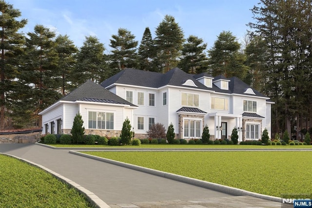 view of front of property with a standing seam roof, metal roof, and a front lawn