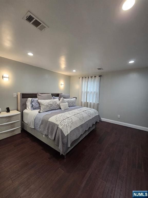 bedroom with dark hardwood / wood-style floors