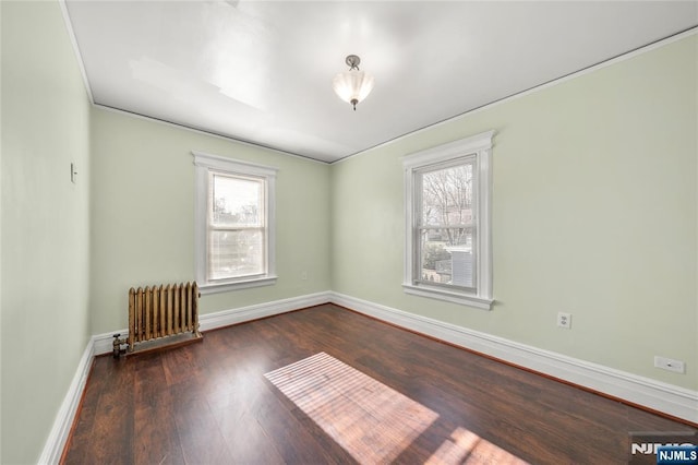 unfurnished room with dark wood-type flooring and radiator