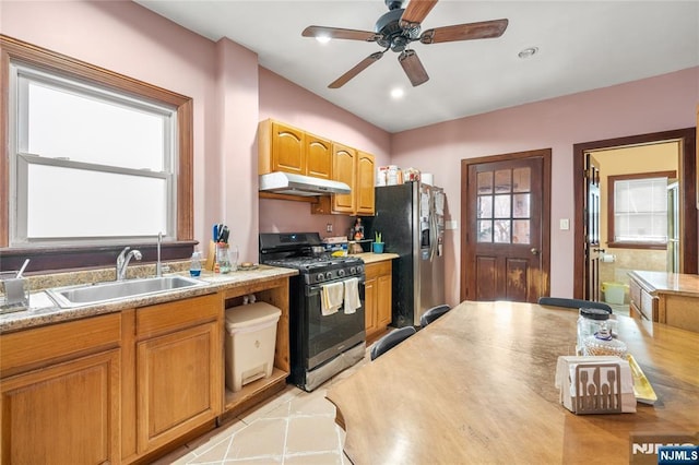 kitchen featuring sink, stainless steel appliances, ceiling fan, and light tile patterned flooring