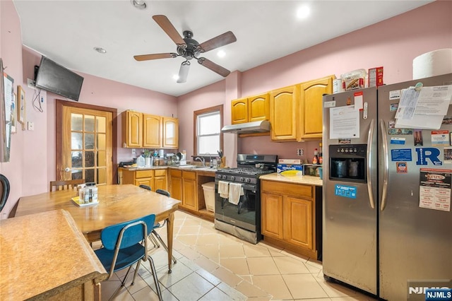 kitchen featuring light tile patterned flooring, ceiling fan, stainless steel appliances, and sink