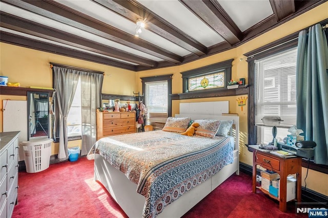 bedroom featuring beam ceiling and dark colored carpet