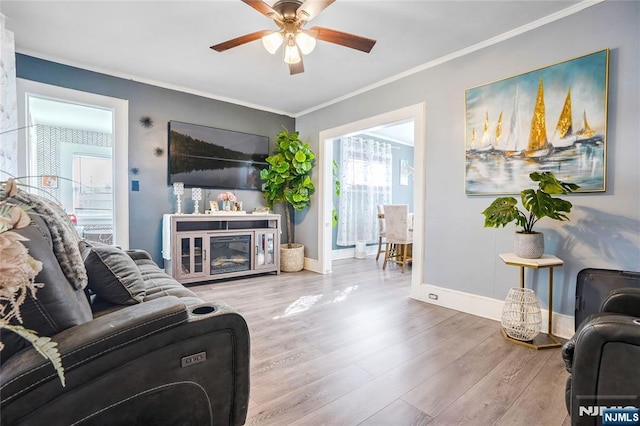 living room featuring crown molding, ceiling fan, and hardwood / wood-style floors