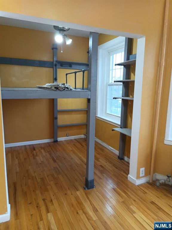 unfurnished bedroom featuring hardwood / wood-style floors