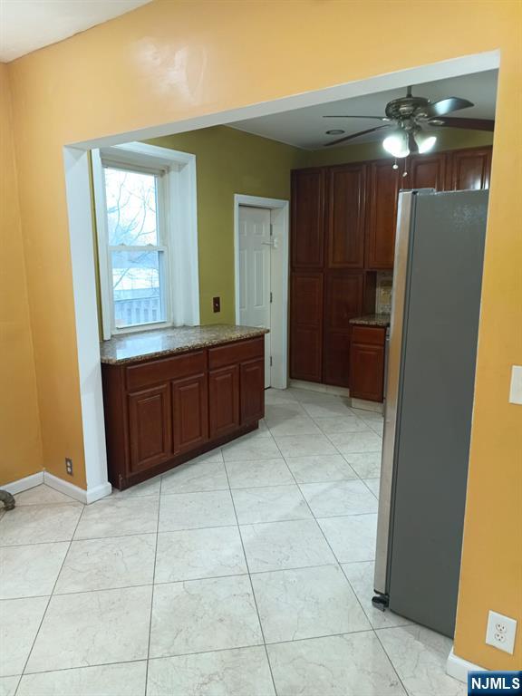 kitchen featuring ceiling fan and stainless steel refrigerator