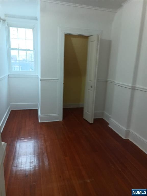 interior space with crown molding and dark hardwood / wood-style floors