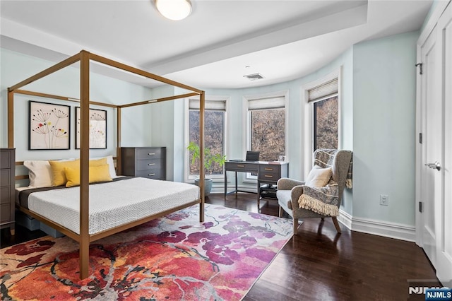 bedroom with dark hardwood / wood-style flooring