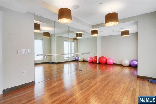 exercise area with wood-type flooring