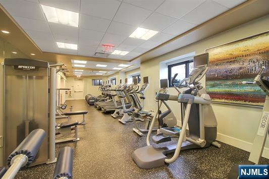 exercise room with a paneled ceiling