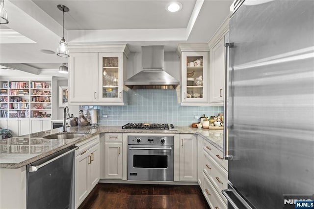 kitchen featuring white cabinetry, stainless steel appliances, and wall chimney exhaust hood