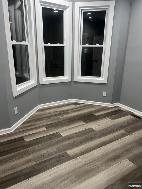 spare room featuring dark hardwood / wood-style floors