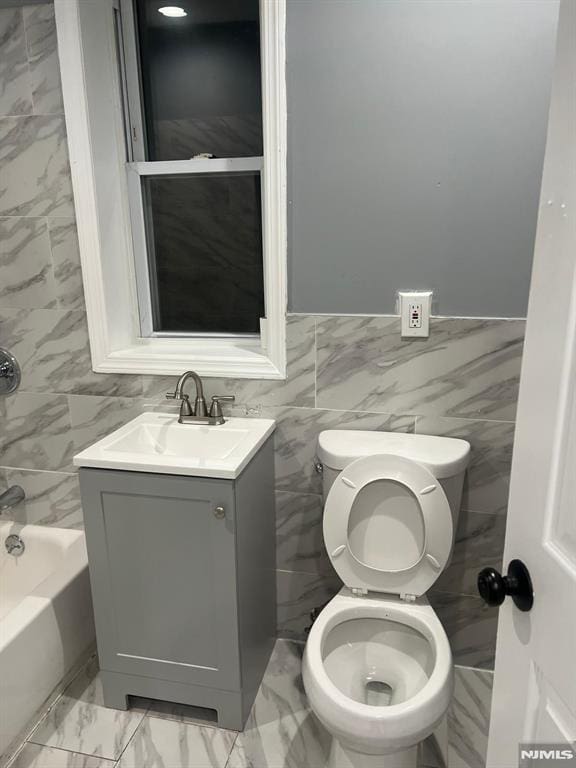 full bathroom featuring vanity, tile walls, shower / bathtub combination, and toilet