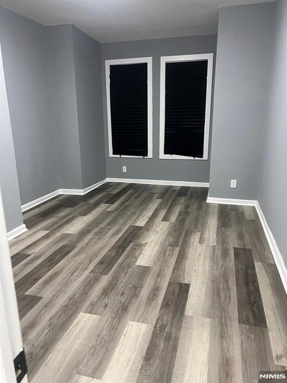 empty room featuring dark hardwood / wood-style flooring