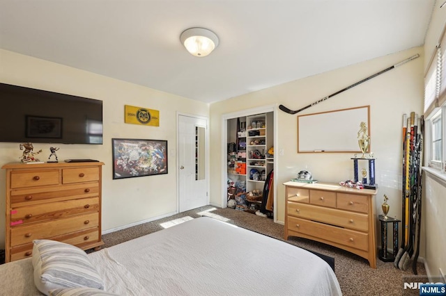 bedroom with dark colored carpet and a closet