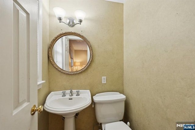 bathroom featuring sink and toilet