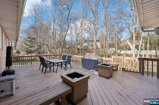 wooden deck featuring a fire pit