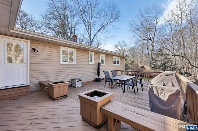 wooden deck featuring a fire pit