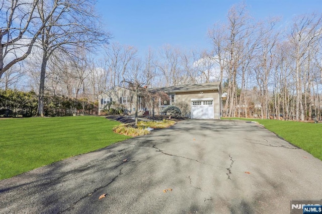 view of front of house with a garage and a front yard