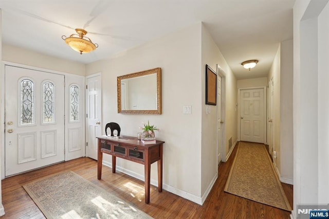 entryway with hardwood / wood-style floors