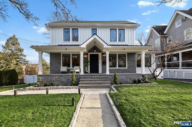 view of front of home featuring covered porch and a front yard