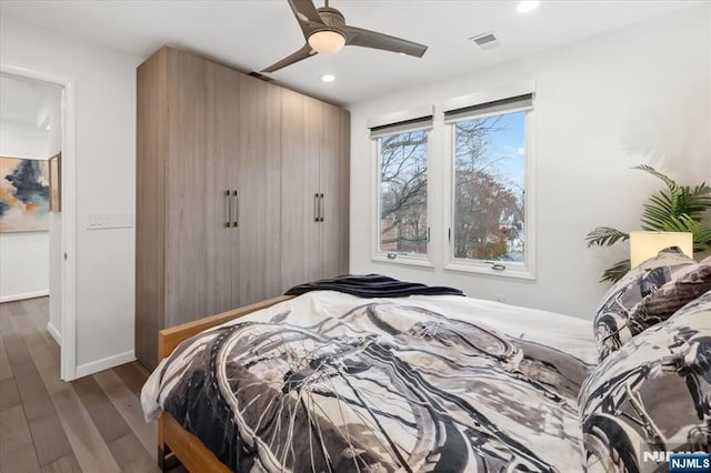 bedroom with wood-type flooring and ceiling fan