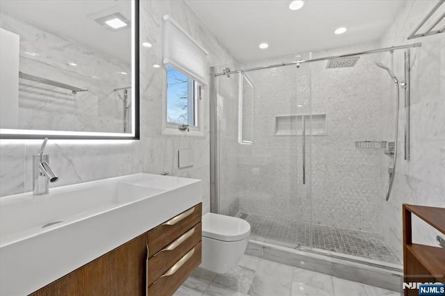 bathroom featuring vanity, toilet, and a shower with shower door