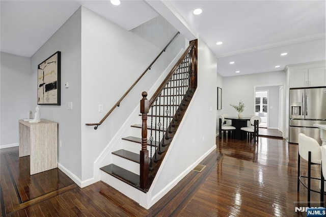 staircase with hardwood / wood-style floors