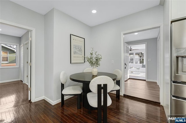 dining space with dark hardwood / wood-style floors