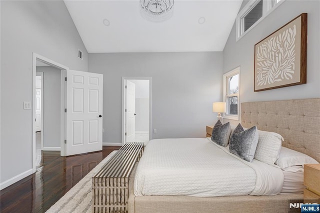 bedroom featuring high vaulted ceiling and dark hardwood / wood-style floors