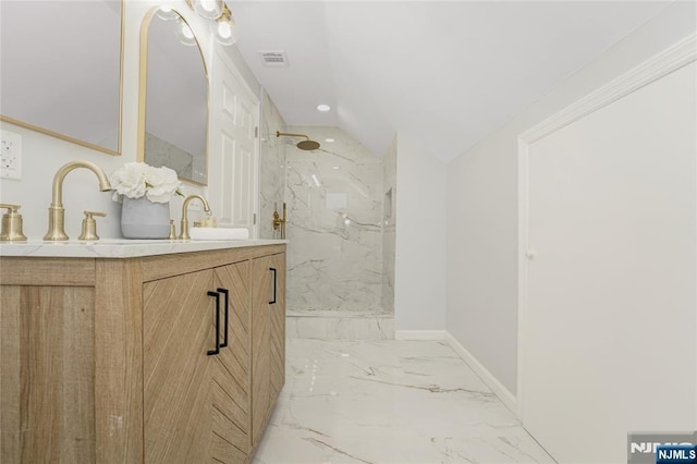 bathroom featuring vanity and tiled shower