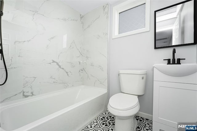 full bathroom with vanity, tiled shower / bath, and toilet