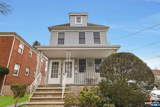 american foursquare style home with covered porch