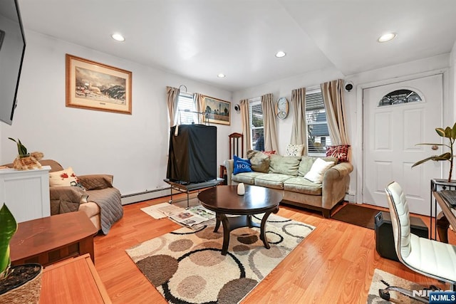 living area featuring a baseboard heating unit, recessed lighting, and wood finished floors