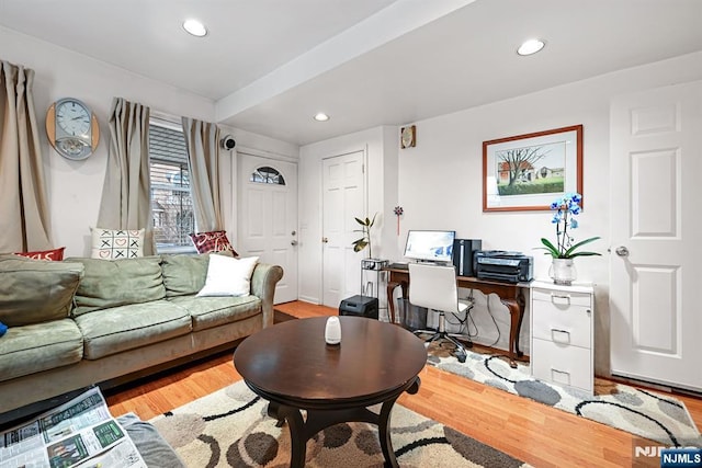 living room with light wood-type flooring and recessed lighting