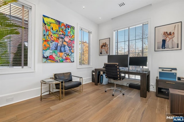 office space with light wood-type flooring